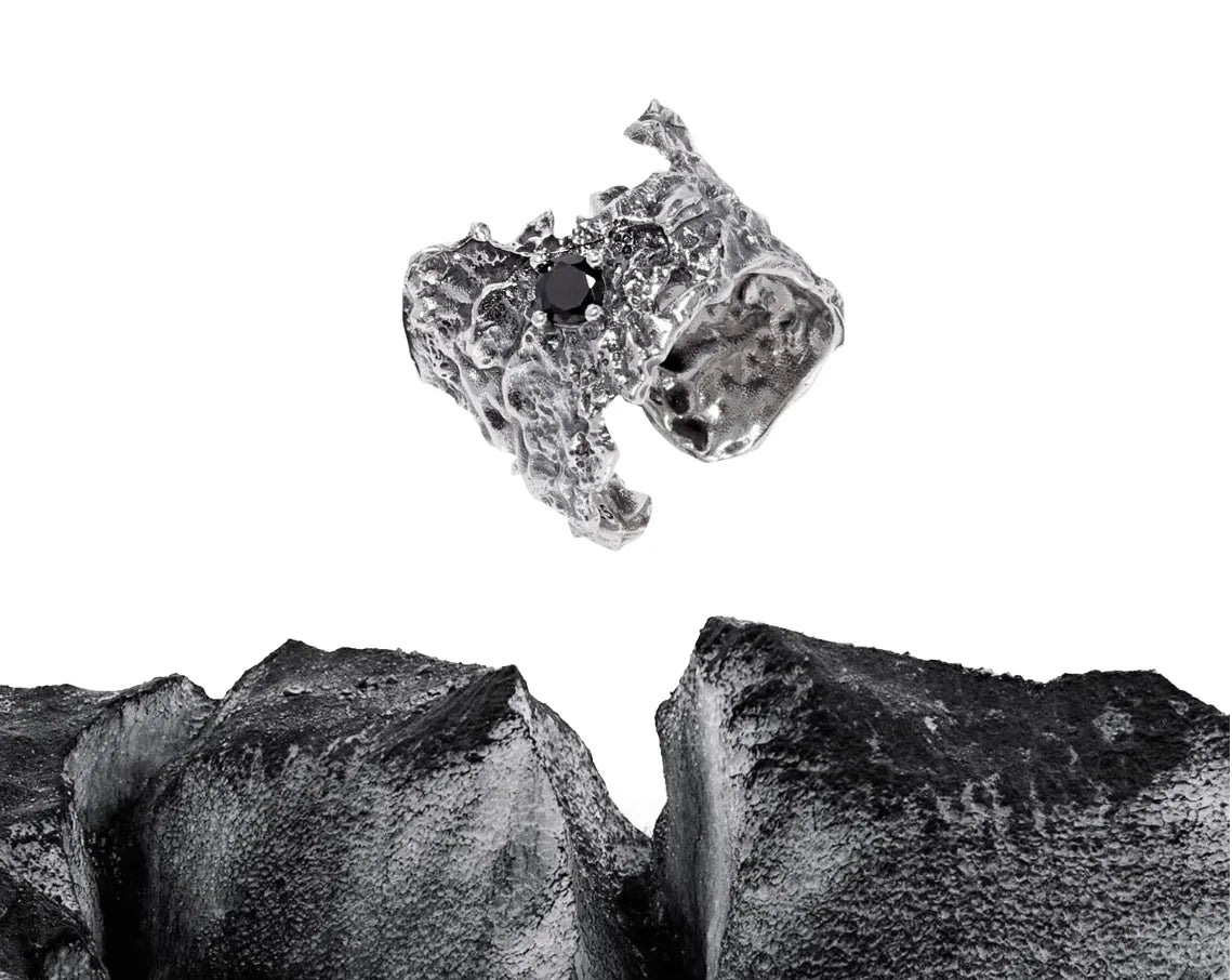 Close-up of a metallic object with a textured surface on a white background