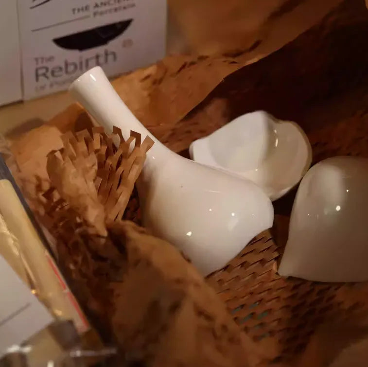 White ceramic items in a woven basket with a blurred background