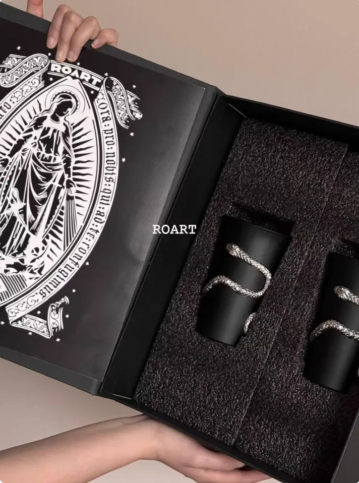 Black gift box with 'ROART' branding containing two black tumblers.