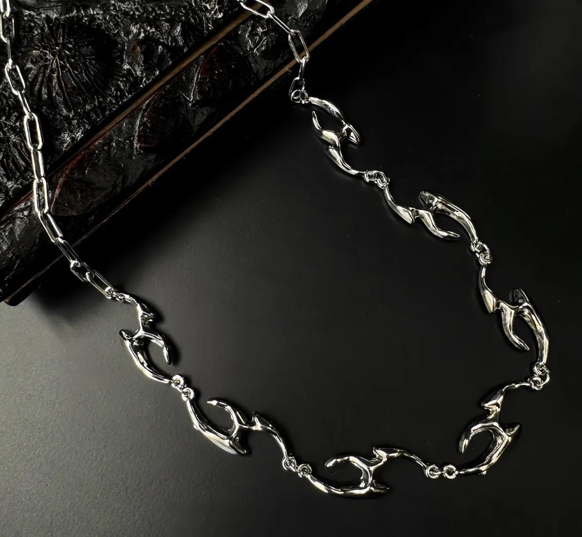 Silver chain bracelet on a dark textured surface