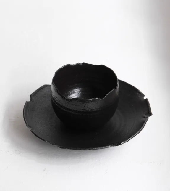 Black ceramic bowl on a white background