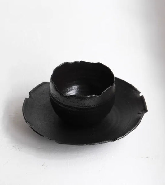 Black ceramic bowl on a white background