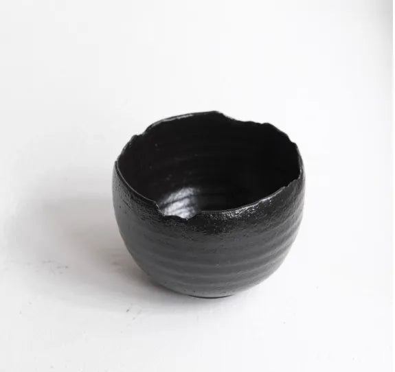 Black ceramic bowl on a white background