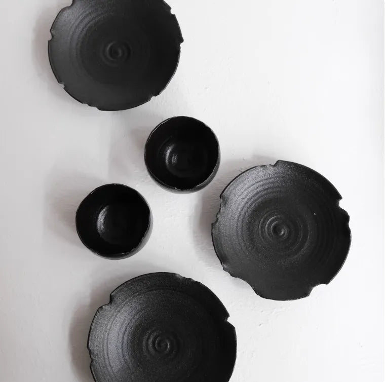 Set of black ceramic bowls on a white background