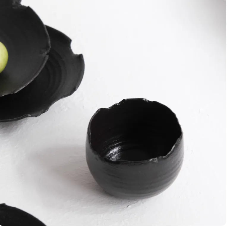 Black ceramic bowls on a white background