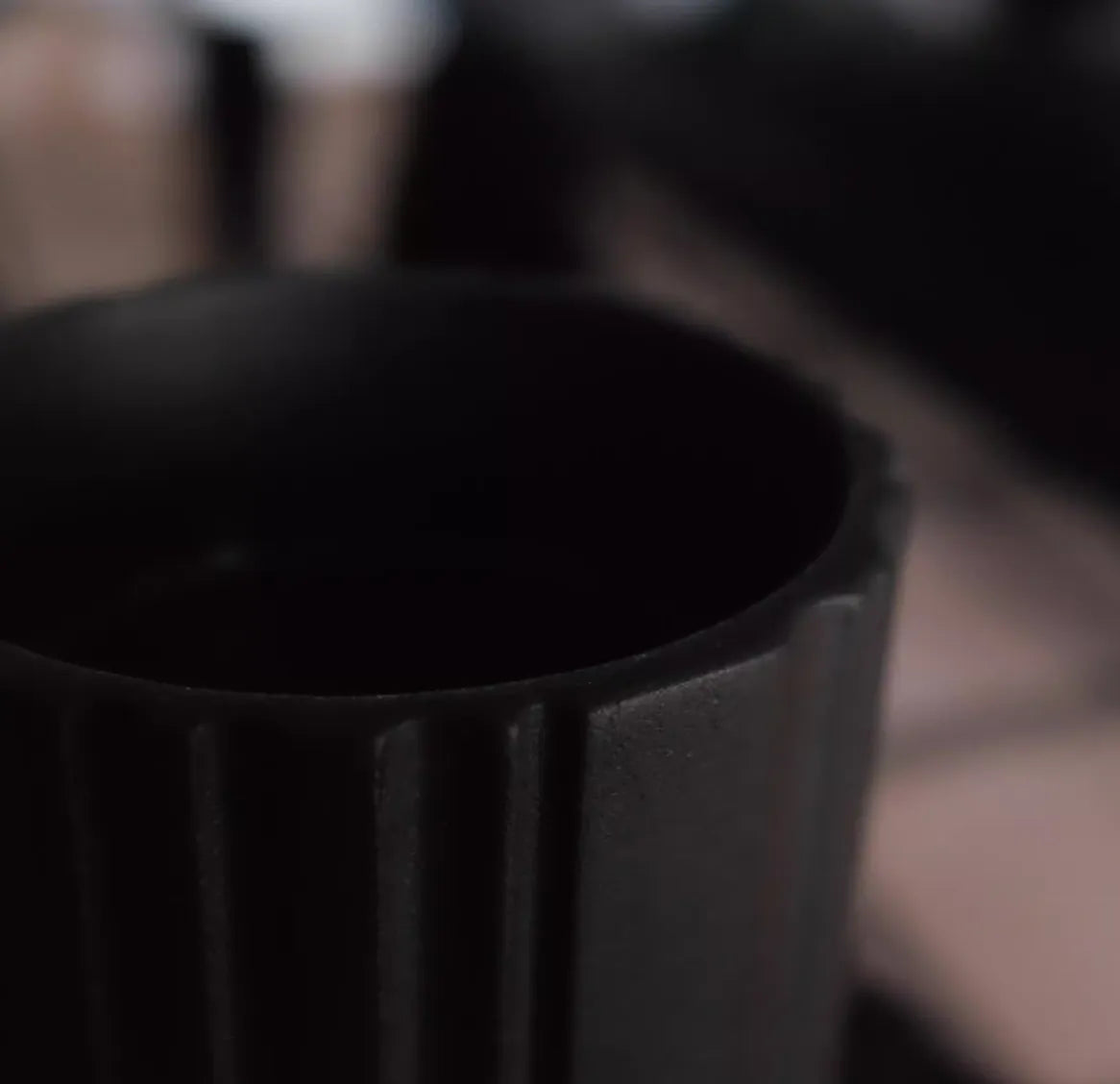 Close-up of a black cylindrical object with a blurred background